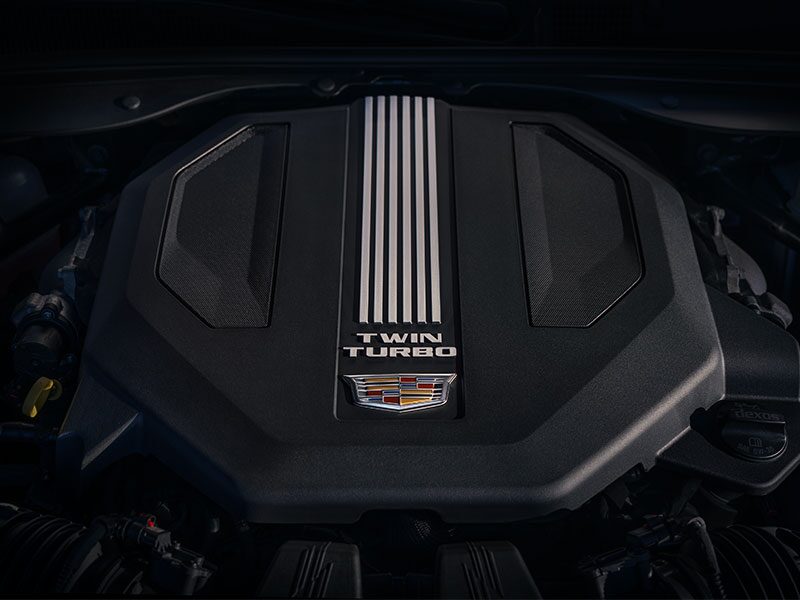 The 2026 Cadillac CT5 Steering Wheel and View of 33" Display Screen Outlooking Industrial Buildings