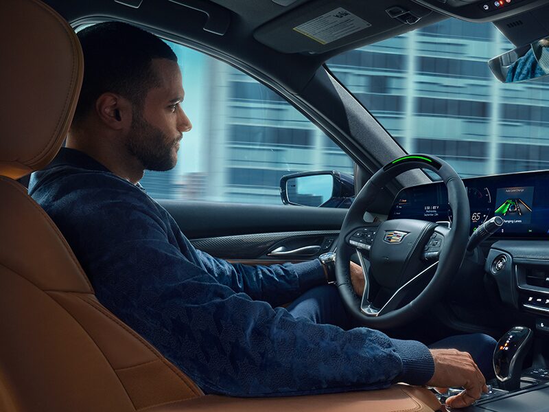 A Man Driving a 2026 Cadillac CT5 Utilizing the Super Cruise Feature