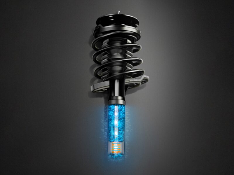 The 2026 Cadillac Escalade Suspension Part on Gray Background