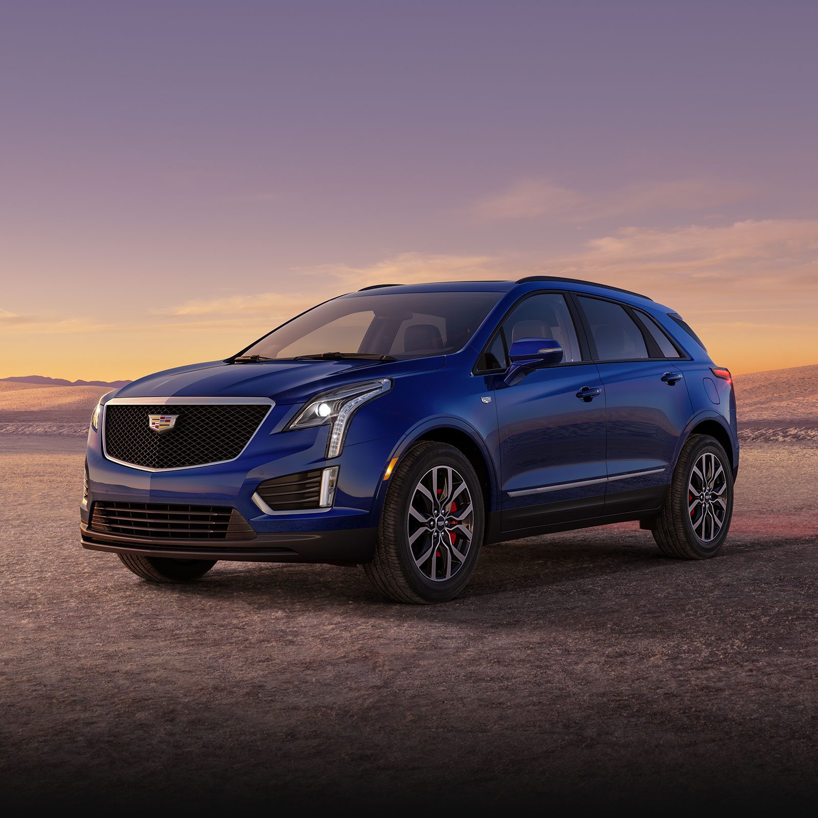 The Dark Moon Blue Metallic Cadillac XT5 Parked During the Sunset in Desert