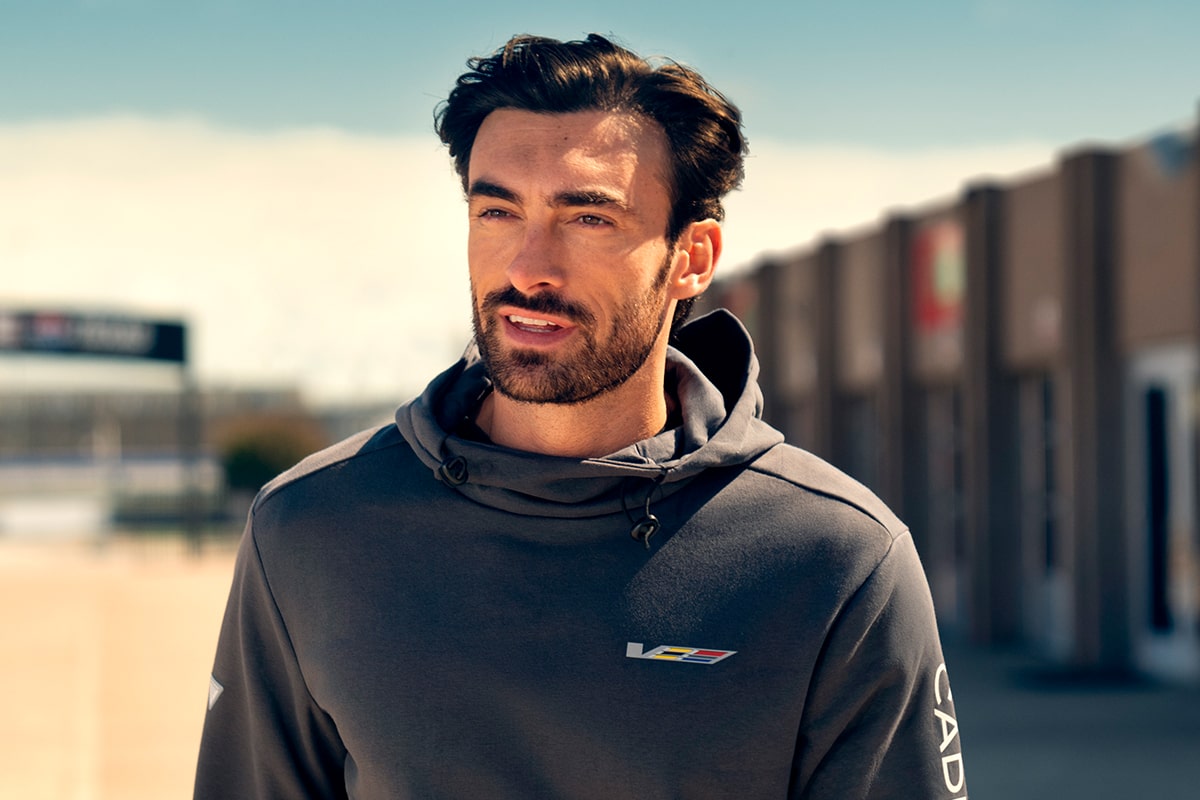 Close-up of a Cadillac Racing Team Member Looking into the Distance Wearing a V-Series Hoodie