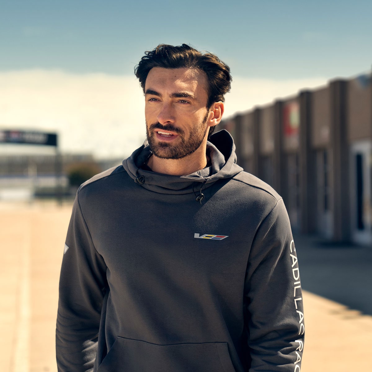 Close-up of a Cadillac Racing Team Member Looking into the Distance Wearing a V-Series Hoodie