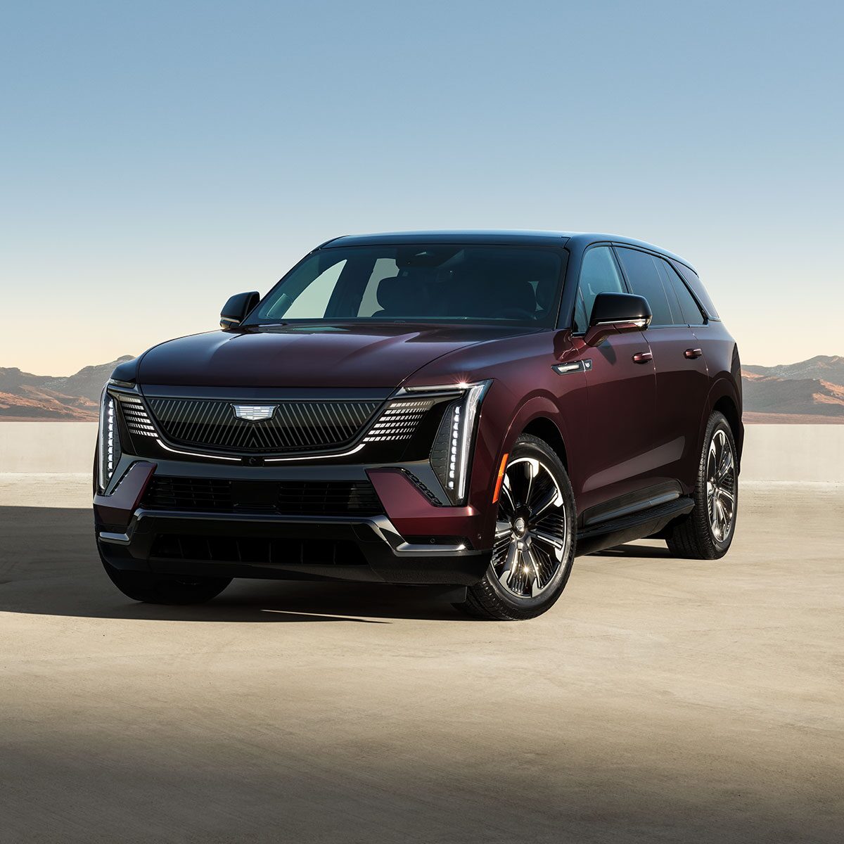 Three-quarters Driver Side View of the 2026 ESCALADE IQ Long Range EV Parked in the Desert