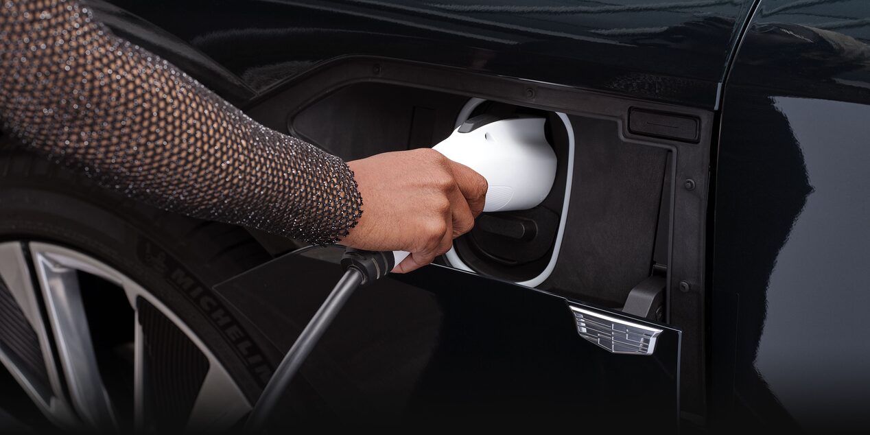 A Woman Plugs In the Charging Cord to the Charging Port on the Cadillac LYRIQ